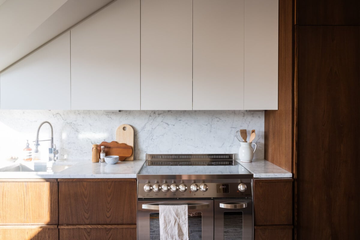 A Light Penthouse Apartment with Built-In Bookshelves 12 kitchen cabinets under slanted ceiling