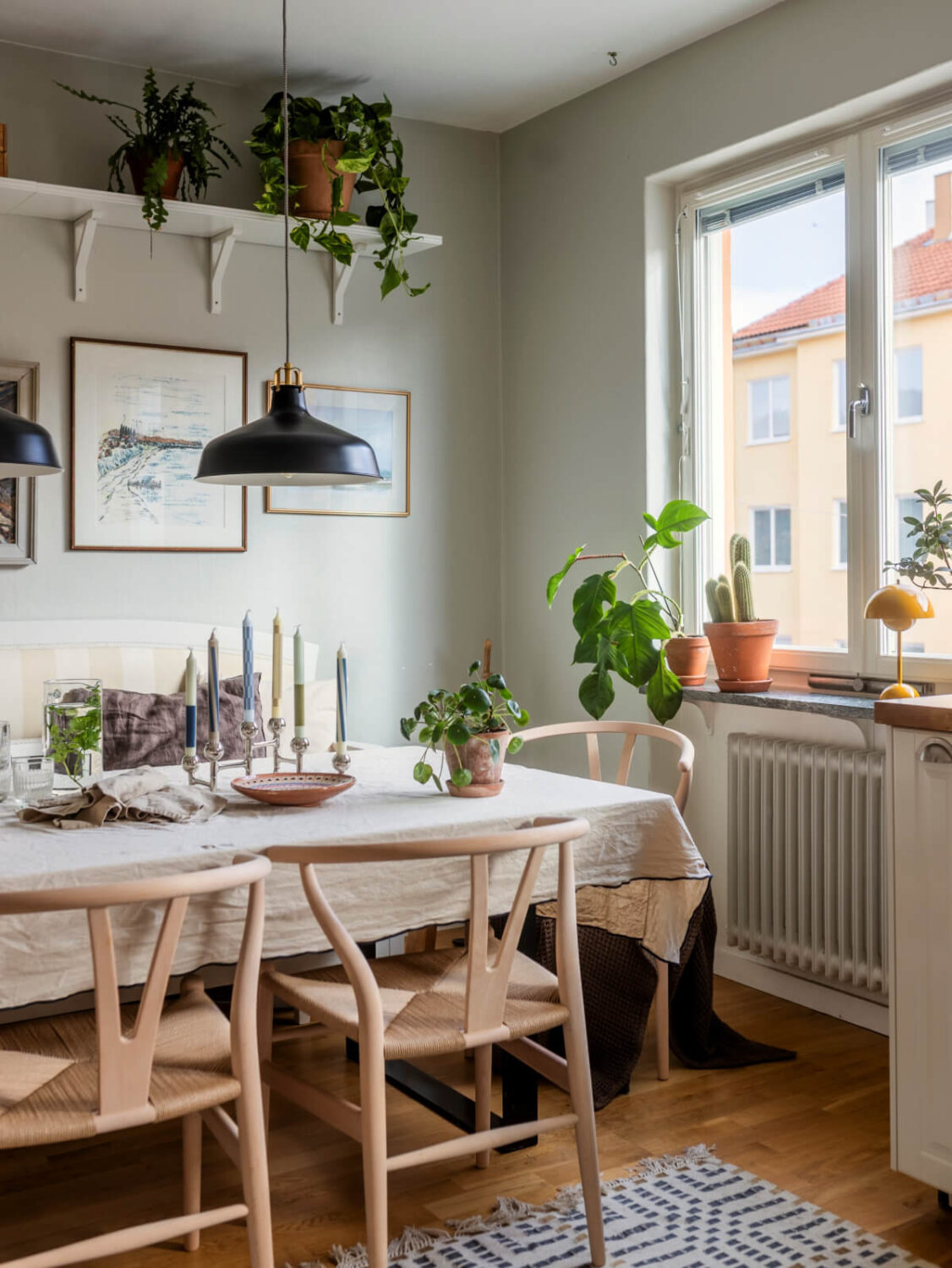 Cozy Plant-Filled Interiors in a 1940s Apartment 13 kitchen dining table with bench