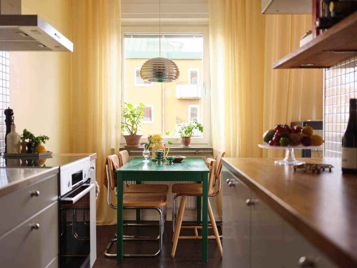 A Light Corner Apartment with Yellow Color Accents 15 kitchen green table yellow curtains