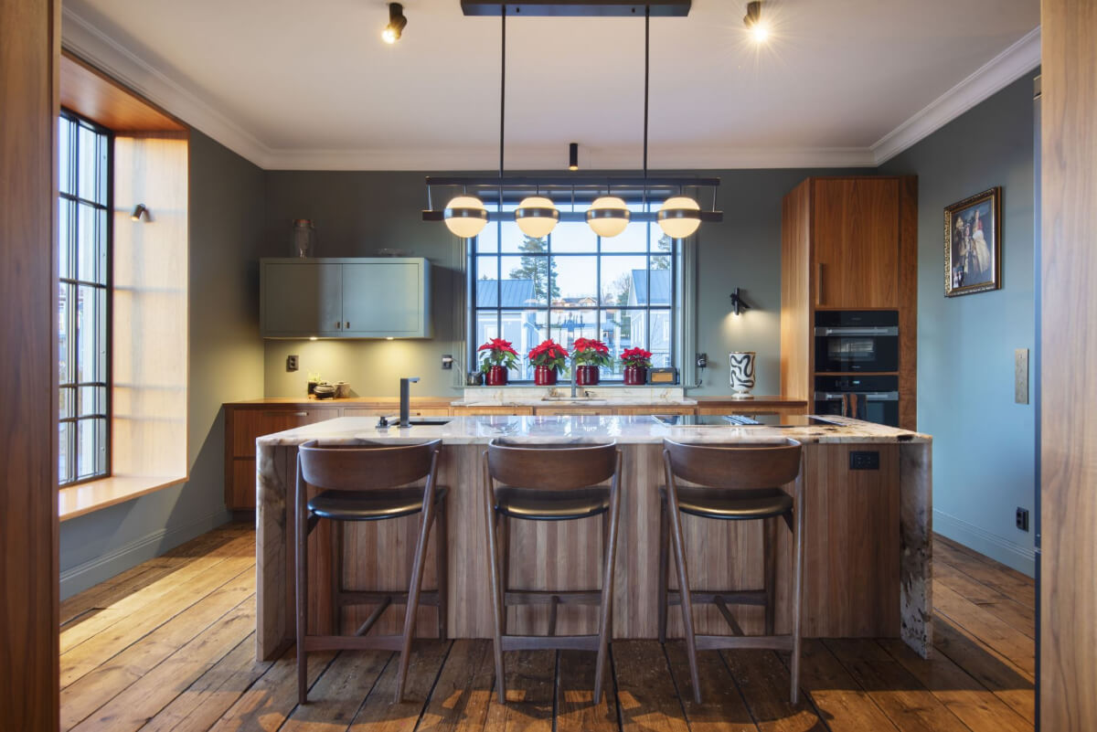English Manor Style Interiors in a New Swedish Home with Lake Views 11 kitchen large island marble top gray walls rustic wooden floorboards