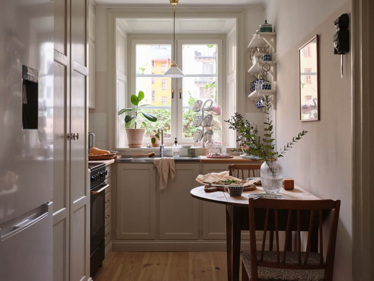 A Charming Vintage Apartment with Historic Wallpapers in Stockholm 6 kitchen large window small table