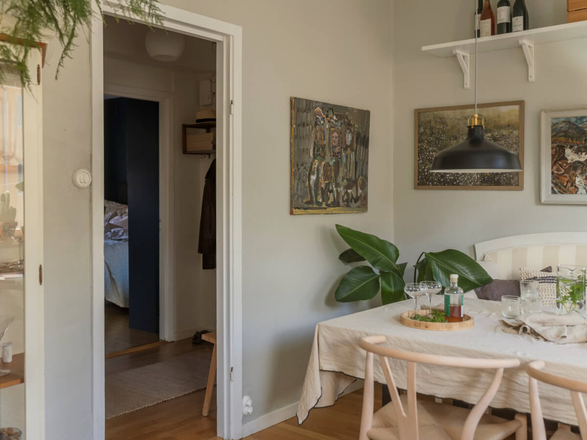 Cozy Plant-Filled Interiors in a 1940s Apartment 15 kitchen light gray walls dining table