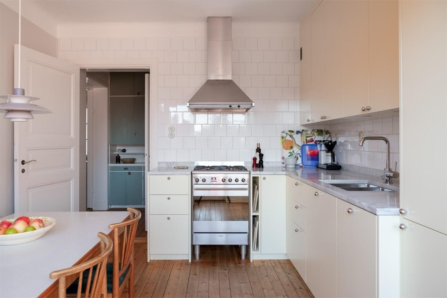 A Stockholm Apartment with a Light Yellow Kitchen 6 kitchen pale yellow cabinets wooden floor