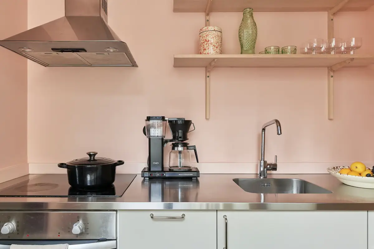 A Colorful Studio Apartment in Stockholm 10 kitchen pink walls shelves A Colorful Studio Apartment in Stockholm