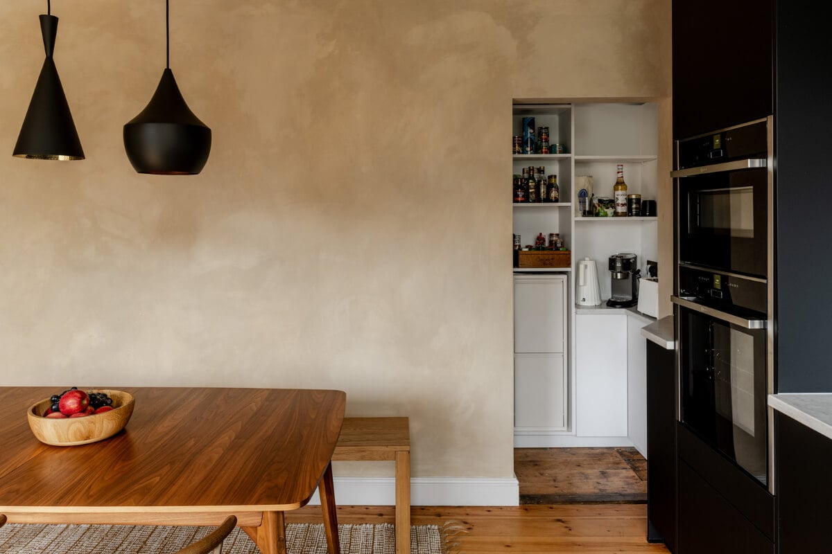 A Contrasting Color Palette in a Renovated Terrace House 6 kitchen plaster walls open pantry