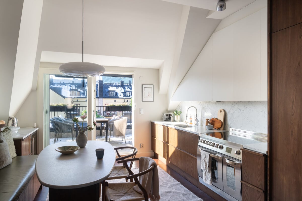 A Light Penthouse Apartment with Built-In Bookshelves 11 kitchen slanted ceiling balcony