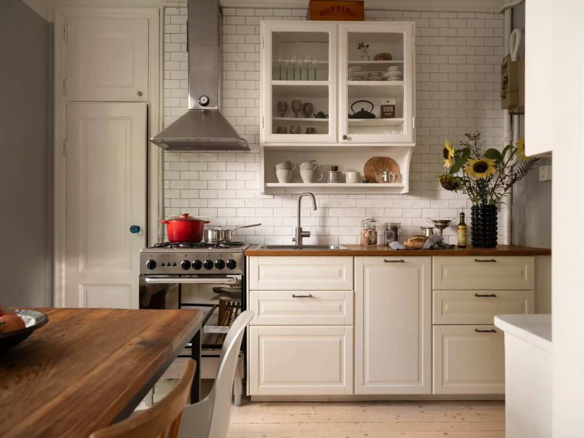 A Charming One-Bedroom Apartment in a 1920s Building 15 kitchen white backsplash tiles glass fronted upper cabinet