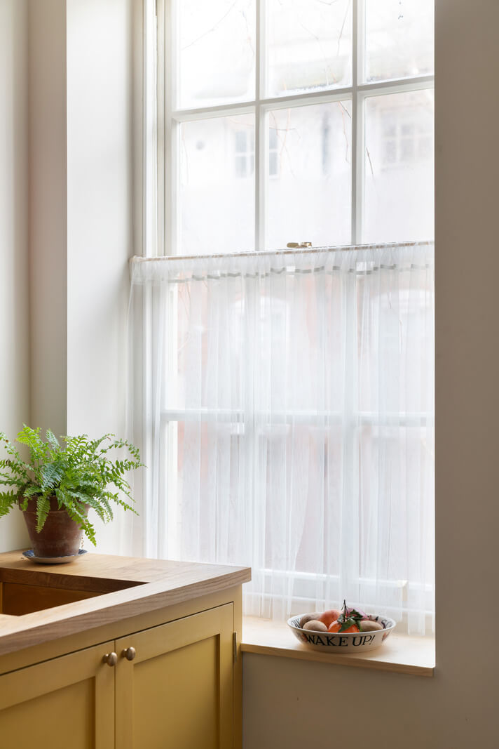 A Tiny Apartment with a Yellow Kitchen in London 3 kitchen window