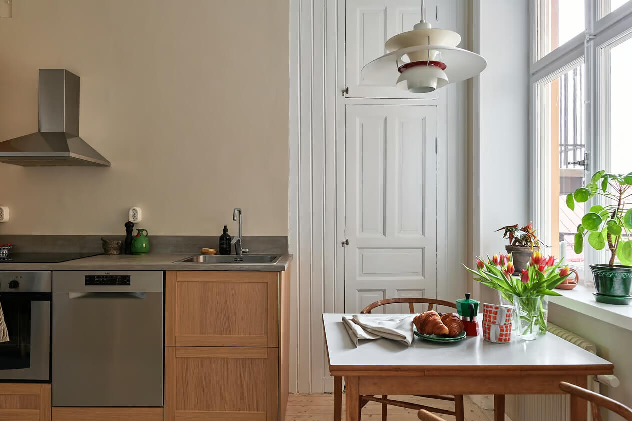 A Charming Swedish Apartment with a Spacious Balcony 15 kitchen with old pantry door