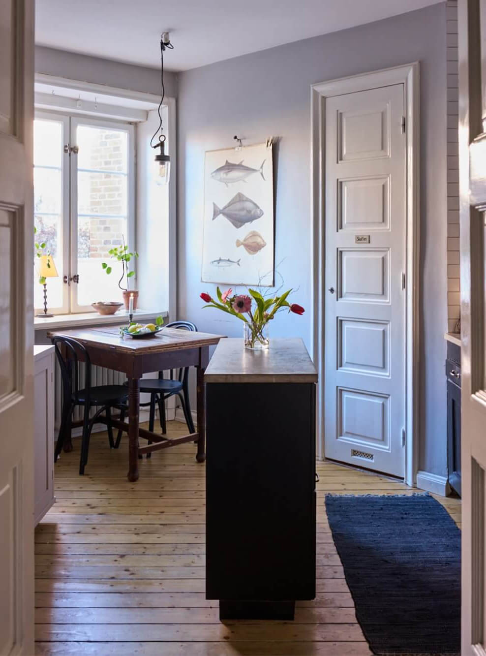 A Charming Apartment with Period Details in Malmö 10 kitchen with wooden table