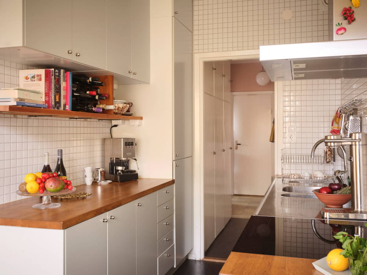 A Light Corner Apartment with Yellow Color Accents 18 kitchen wooden countertop small white tiles