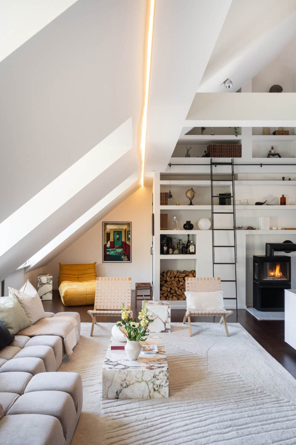 A Light Penthouse Apartment with Built-In Bookshelves 2 light attic living room floor to ceiling bookshelves