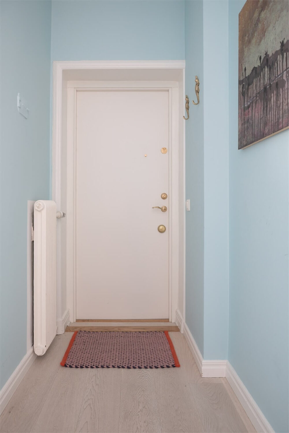A Colorful Basement Duplex Apartment in Stockholm 21 light blue hallway