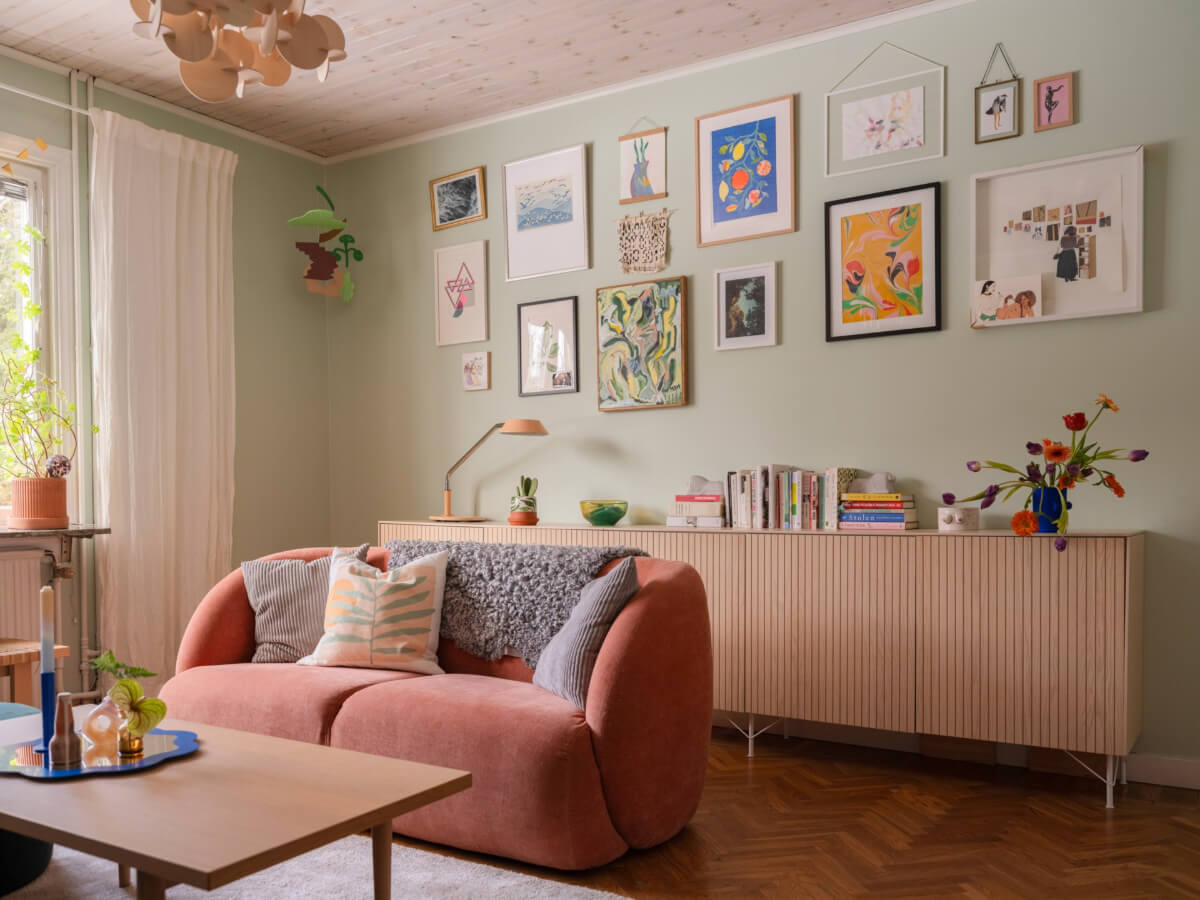 Colorful Decor in a Charming Family Duplex Apartment in Stockholm 2 light green living room gallery wall