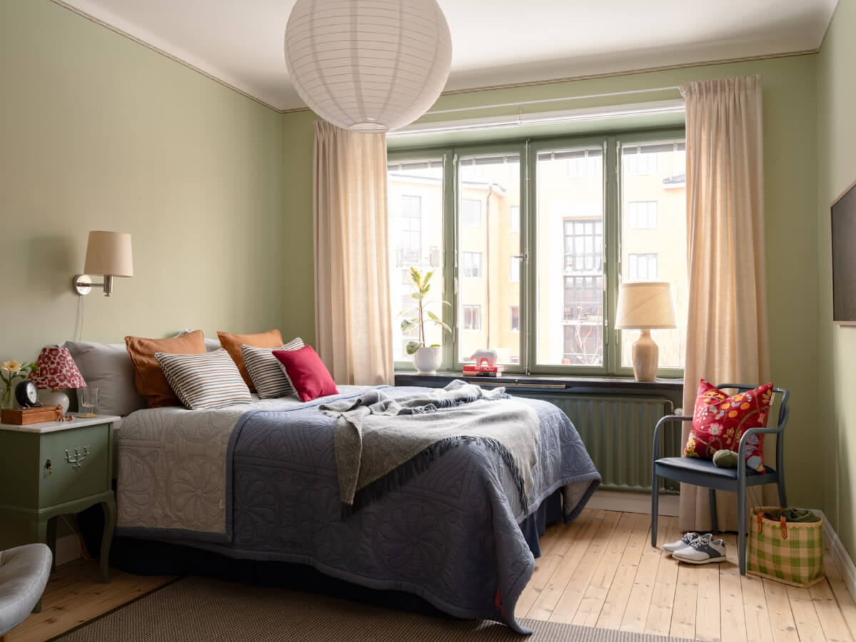 A Beautiful Well-Preserved 1930s Apartment with a Blue Kitchen 15 light green walls bedroom wooden floor