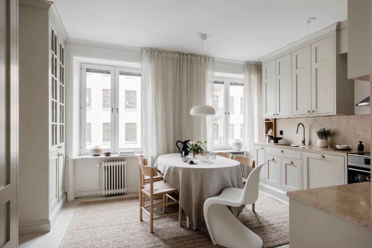 A Light Corner Apartment with an Open Flowing Floor Plan 2 light kitchen dining table jute rug