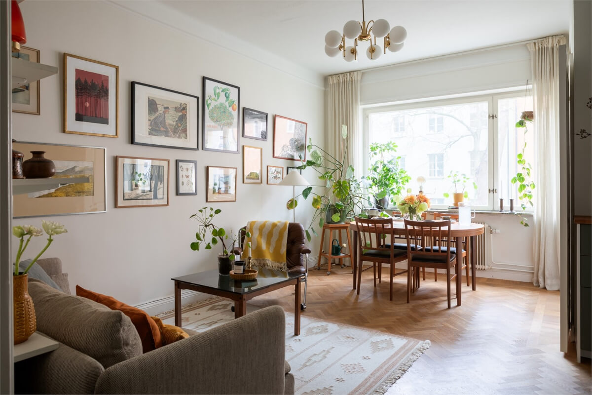 A Small Open-Plan Apartment with Midcentury Furniture 2 light living room gallery wall parquet floor