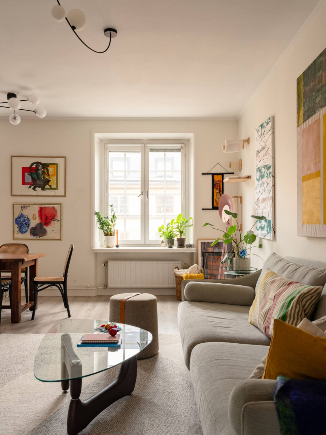 A Pink and Orange Bedroom in a Light Stockholm Apartment 7 light living room glass coffee table