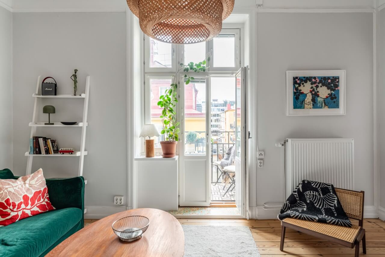 A Small Light-Filled Apartment with a Pink Bedroom 3 light living room green sofa balcony