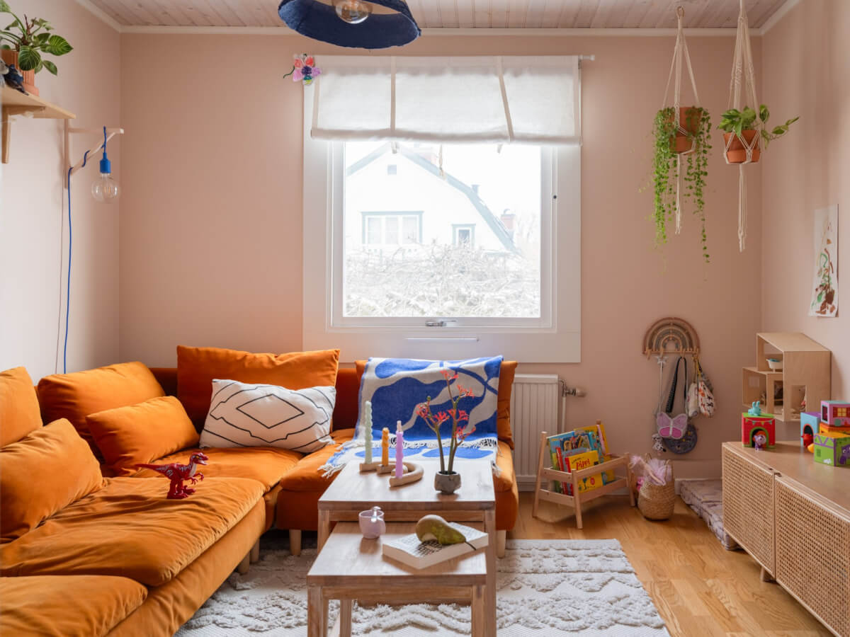 Colorful Decor in a Charming Family Duplex Apartment in Stockholm 17 light pink sitting room ochre sofa