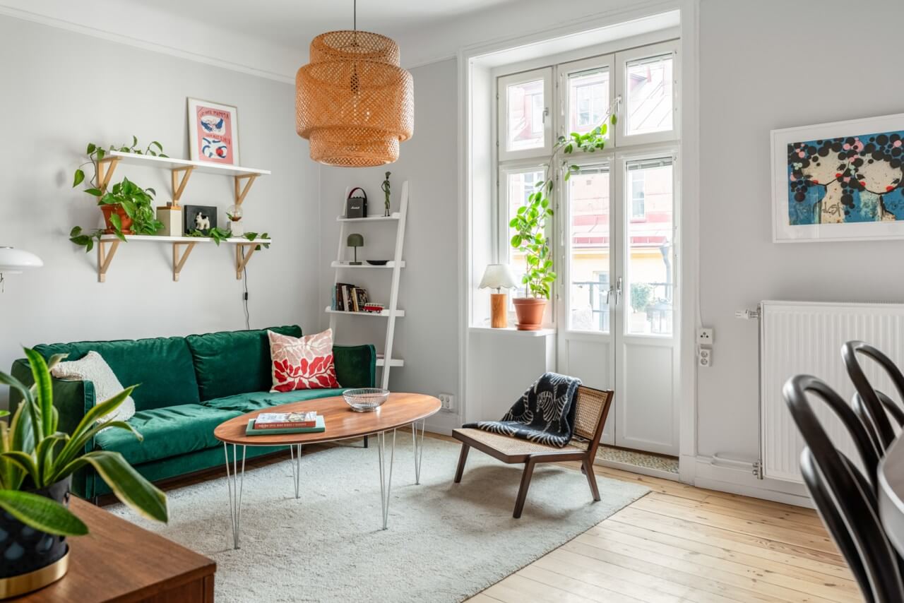 A Small Light-Filled Apartment with a Pink Bedroom 2 light walls living room green sofa wooden floor