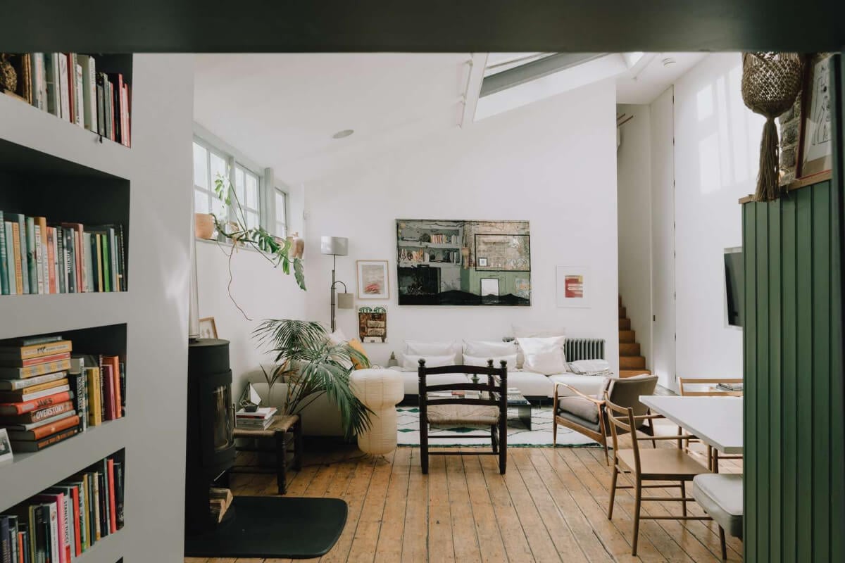 A London Basement Apartment in a Former Wood Workshop 8 living area wooden floor pitched roof with skylights