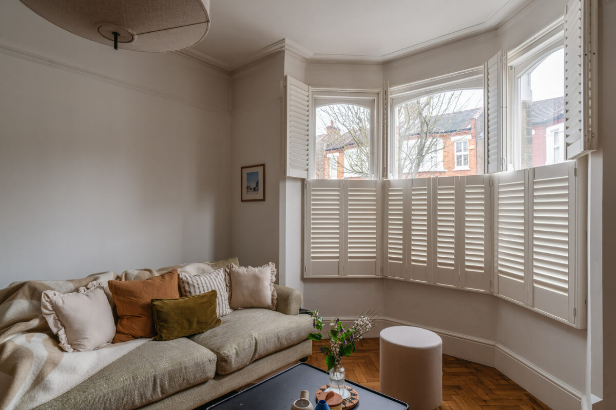 A Charming Garden Apartment in a Victorian House 1 living room bay window with shutters