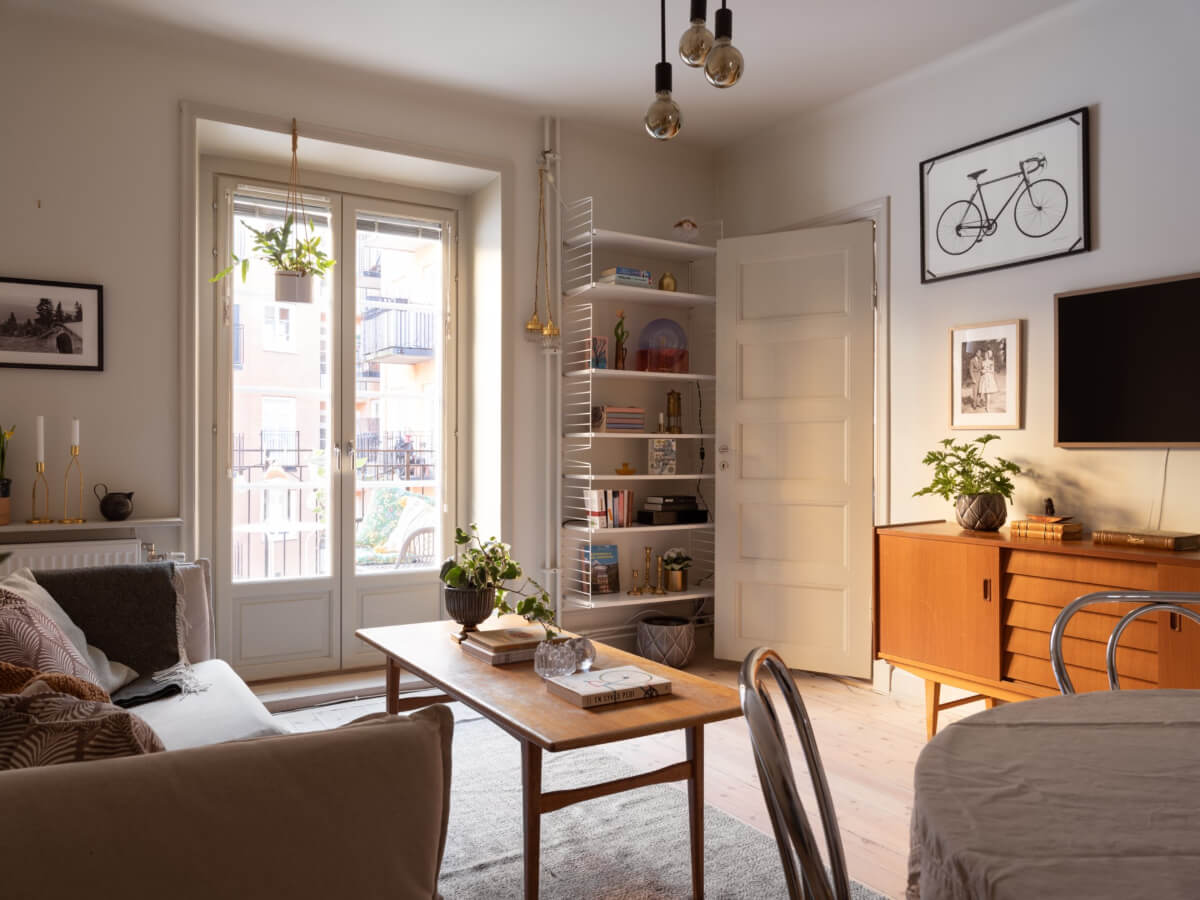 A Charming One-Bedroom Apartment in Södermalm 1 living room bookshelves balcony doors