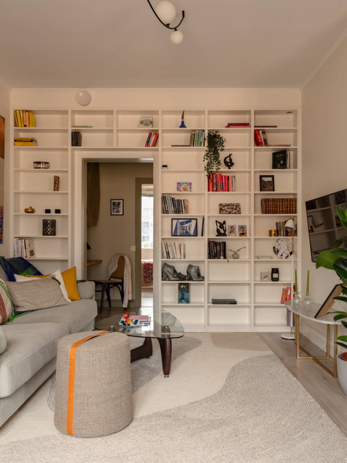 A Pink and Orange Bedroom in a Light Stockholm Apartment 2 living room built-in bookshelves