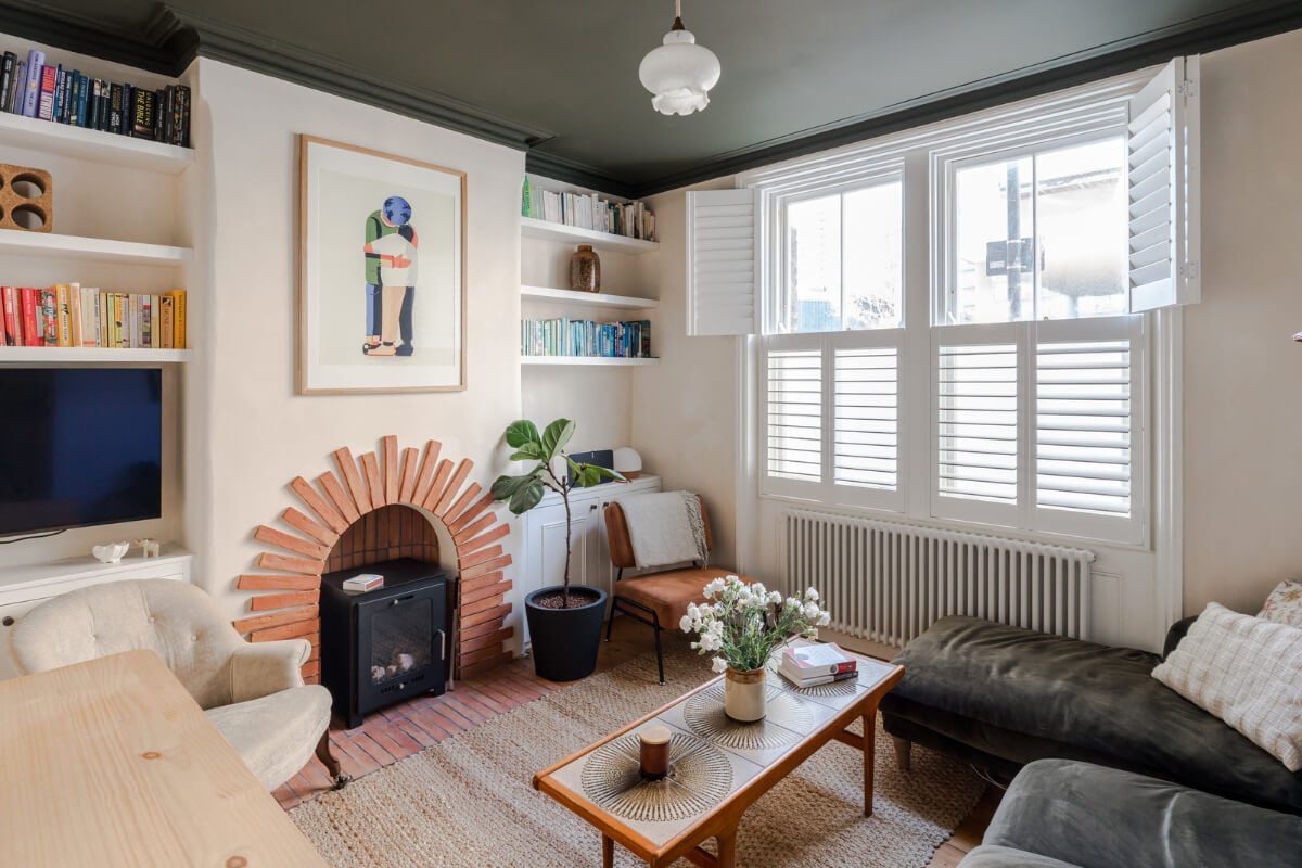 living room dark green ceiling terracotta bricks fireplace