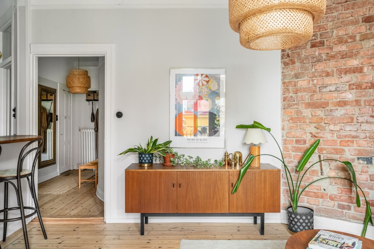 A Small Light-Filled Apartment with a Pink Bedroom 8 living room exposed brick feature wall