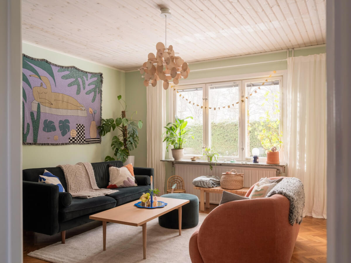 living room herringbone floor green walls