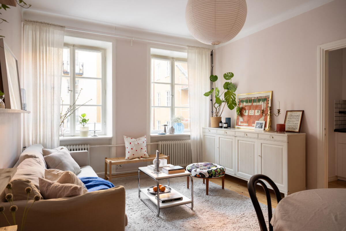 A Small Swedish Apartment with a Light Pink Living Room 5 living room light pink walls wooden floor