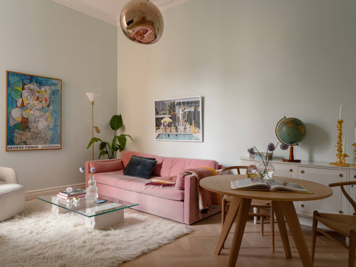 A Small Pink and Blue Apartment with High Ceilings in Stockholm 1 living room pink sofa round table