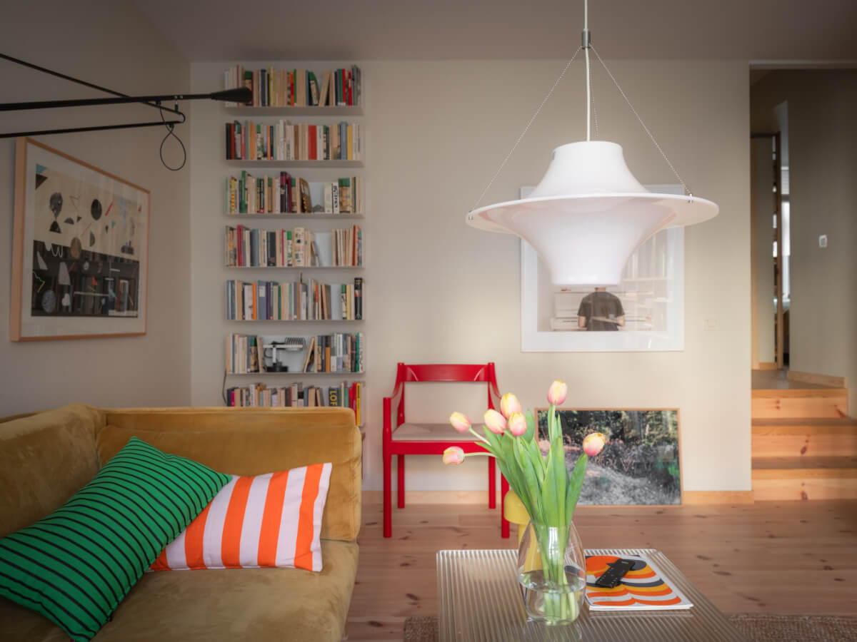 A Design Apartment in an Early 20th Century Building 7 living room velvet sofa bookshelves red accent chair