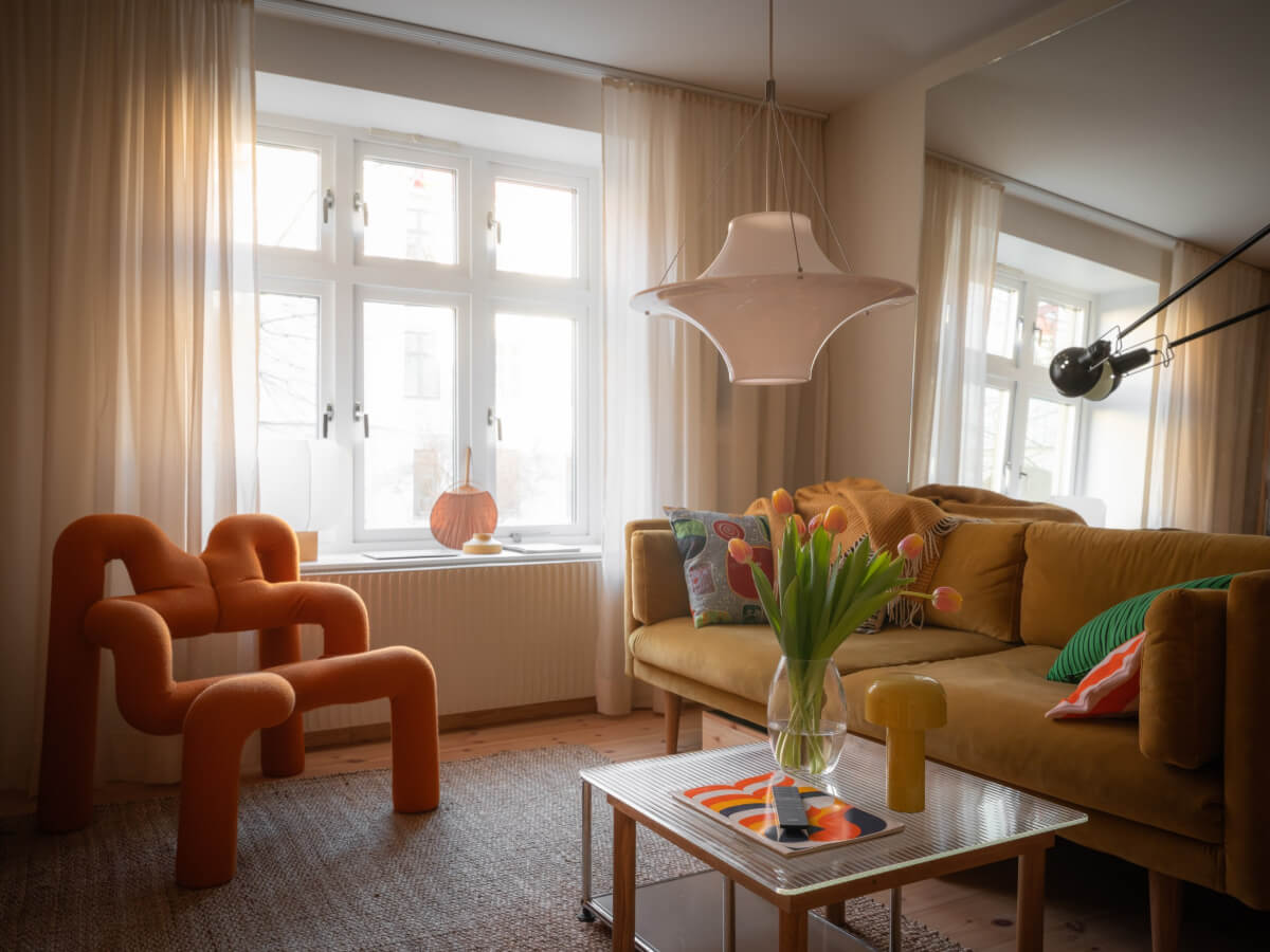 A Design Apartment in an Early 20th Century Building 1 living room velvet sofa large mirror behind couch