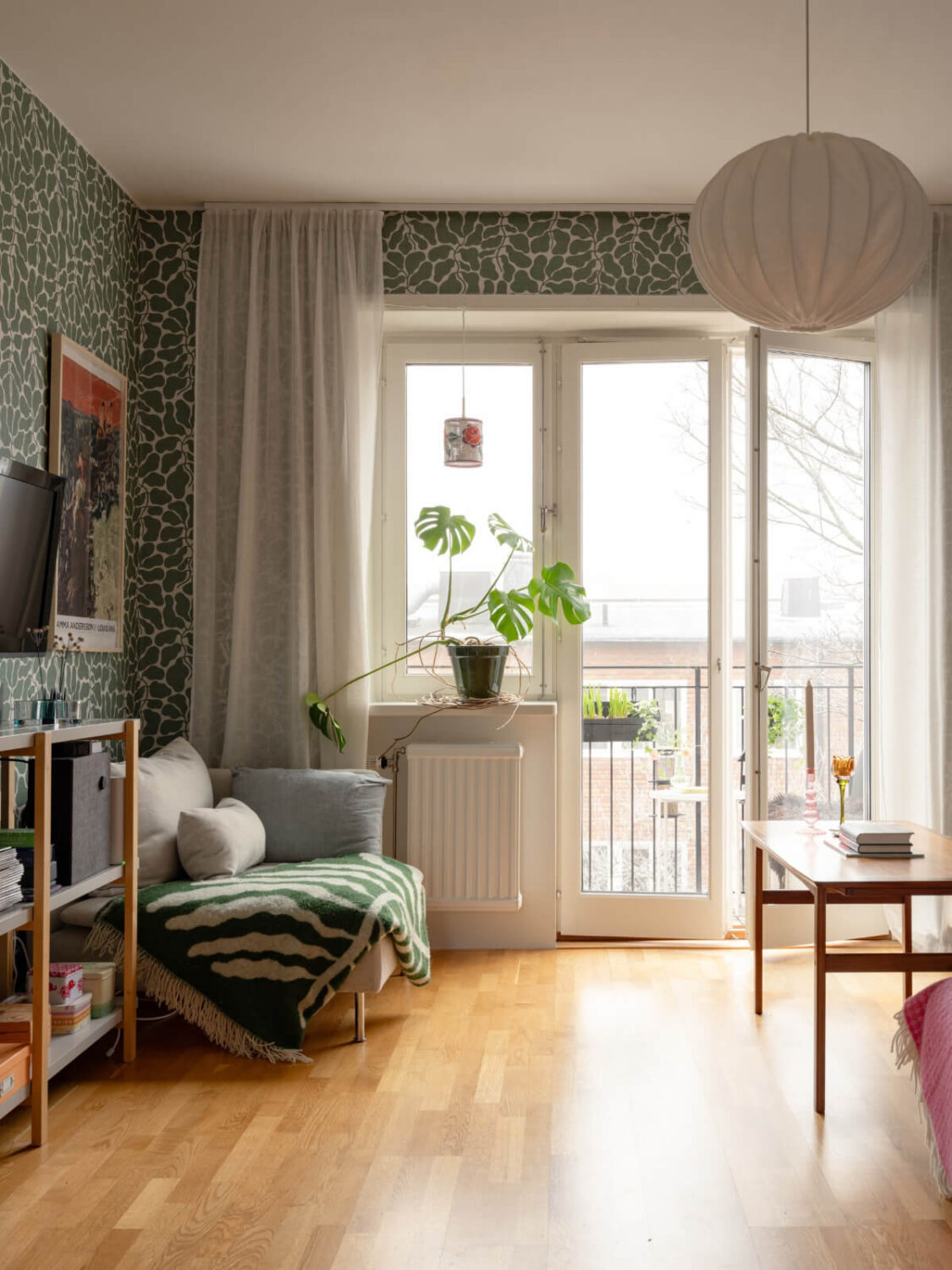 Colorful Wallpapers in a Well-Planned 1940s Apartment 5 living room with balcony doors