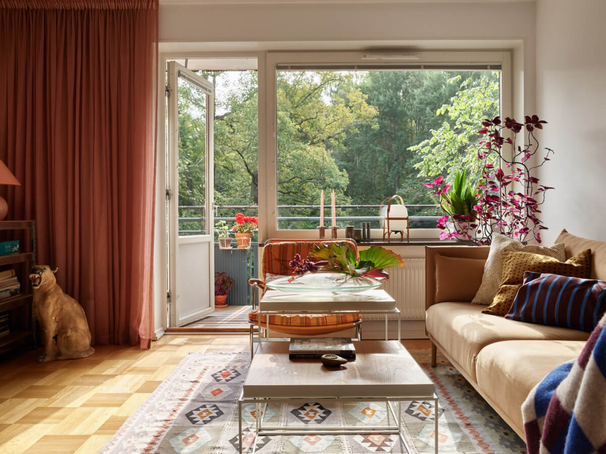 A Lovely Color Palette in a Midcentury Apartment in Sweden 4 living room with balcony parquet floor