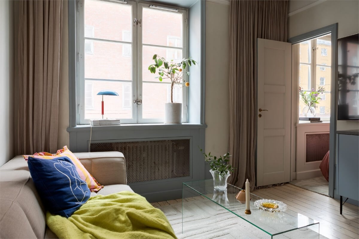 A Small Stockholm Apartment with a Blue Shaker Kitchen 6 living room with door to bedroom