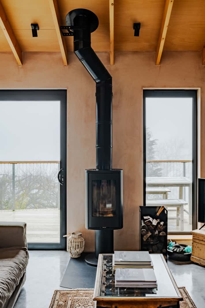 A Japanese-Inspired Timber Home with Views of a Lush Valley 8 log burner