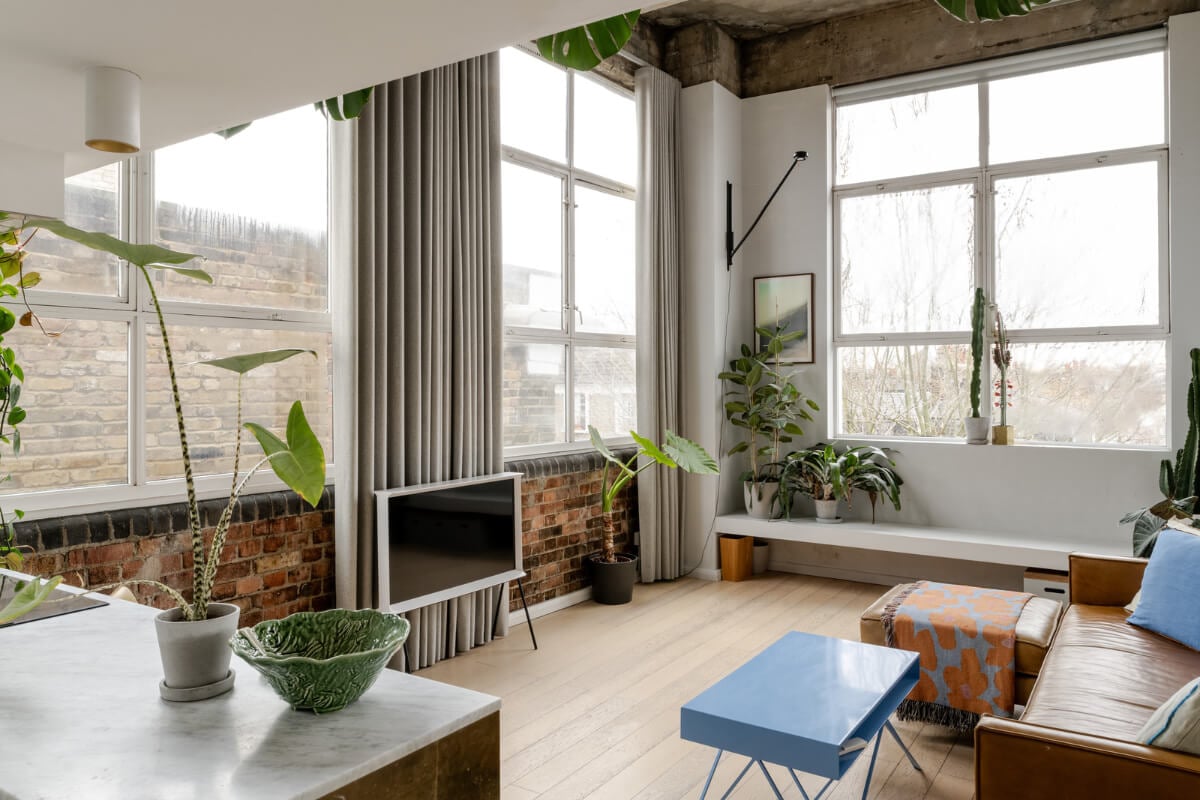 A Plant-Filled Loft Apartment in a Former Clothing Factory 3 london loft exposed brick large windows