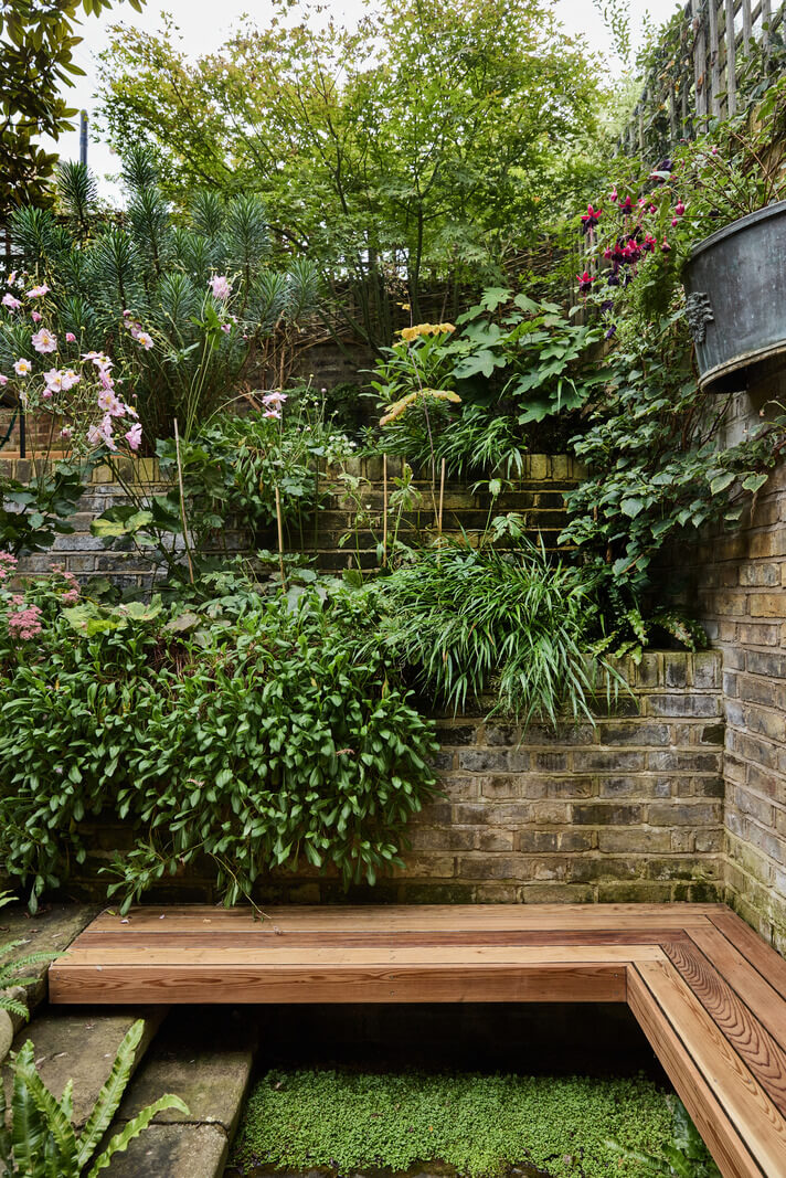 A Renovated Early Victorian Townhouse Decorated in Green Tones 26 lush garden with bench