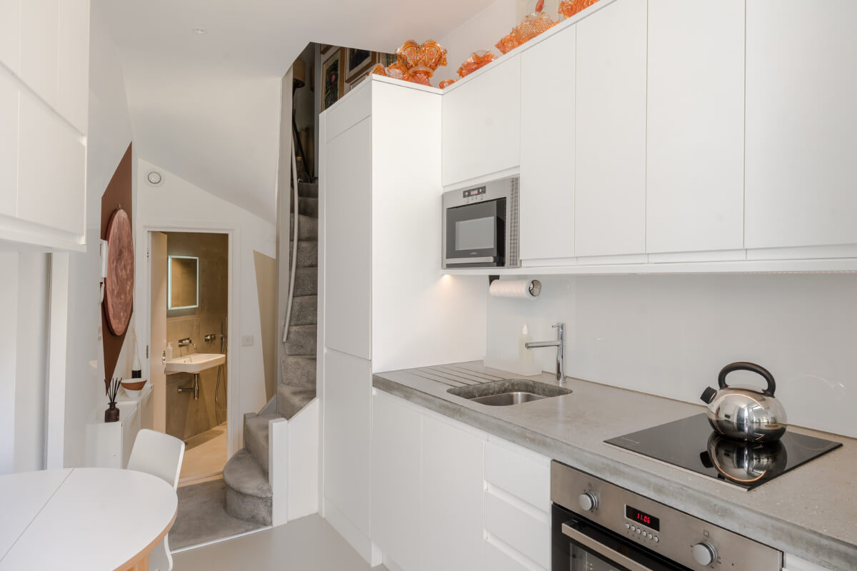 A Narrow Five-Story House with a Roof Garden in London's Clerkenwell 3 modern white kitchen narrow house