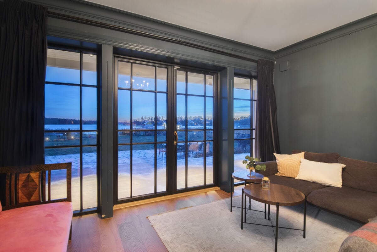 English Manor Style Interiors in a New Swedish Home with Lake Views 24 moody gray sitting room