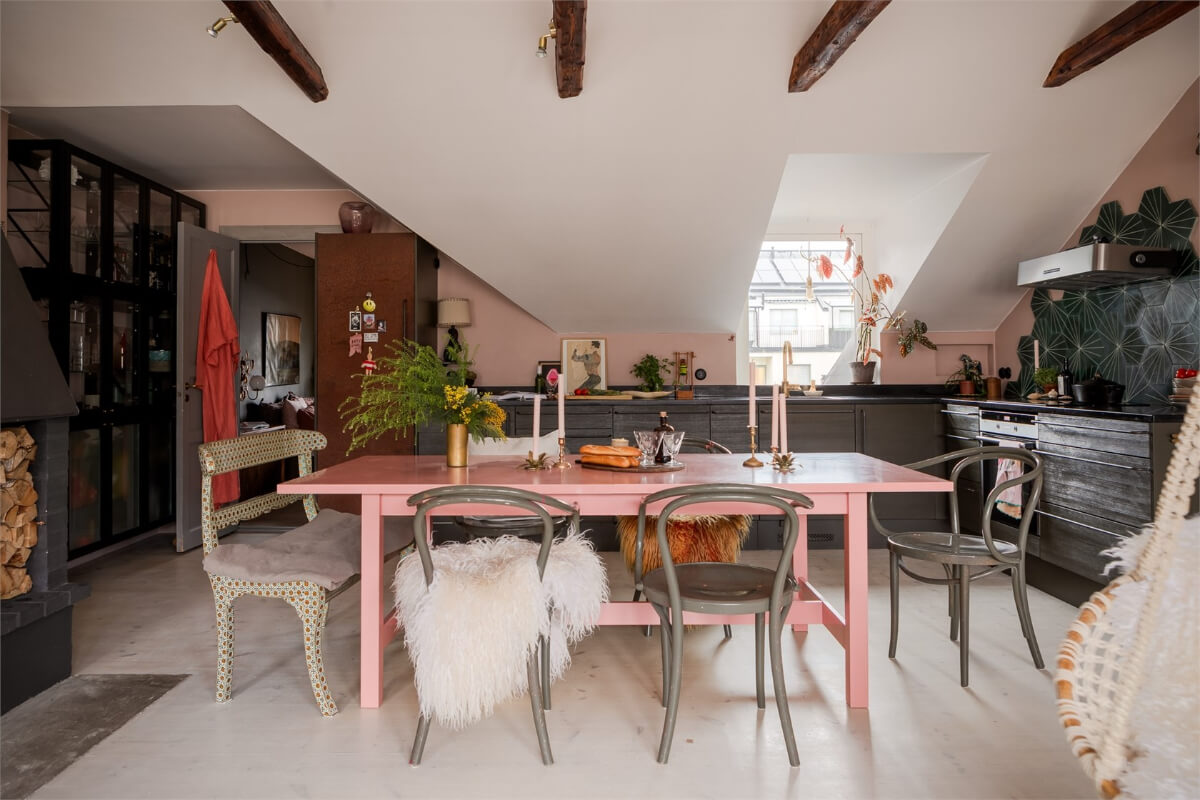 A Colorful Family Attic Apartment in Stockholm 15 open plan kitchen with pink dining table