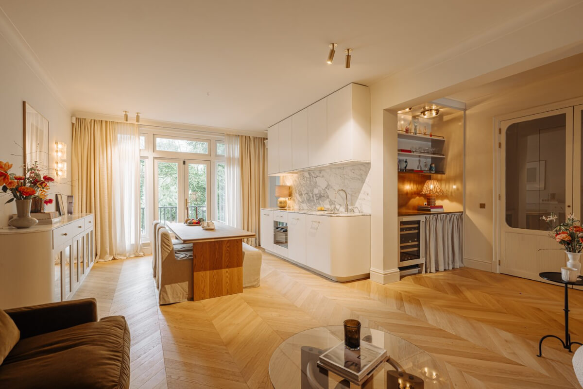 A Luxurious Apartment in Amsterdam with a Lovely Master Suite 1 open plan living room chevron floor curved kitchen