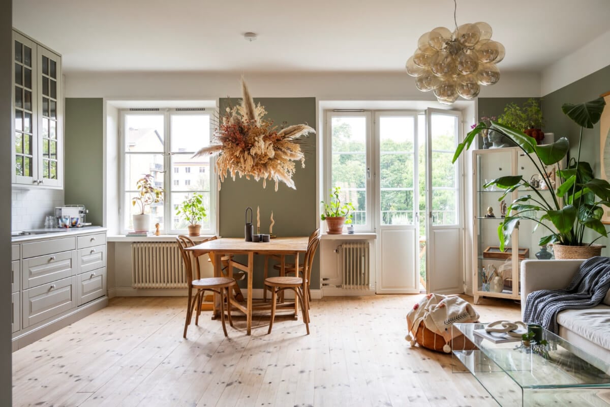 A Light Swedish Apartment with a Green Living Room 3 open plan living room green walls wooden floor