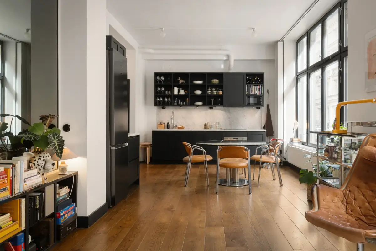 An Apartment with a Mirror Wall in a Former Stockholm Factory 11 open plan living space dark gray kitchen