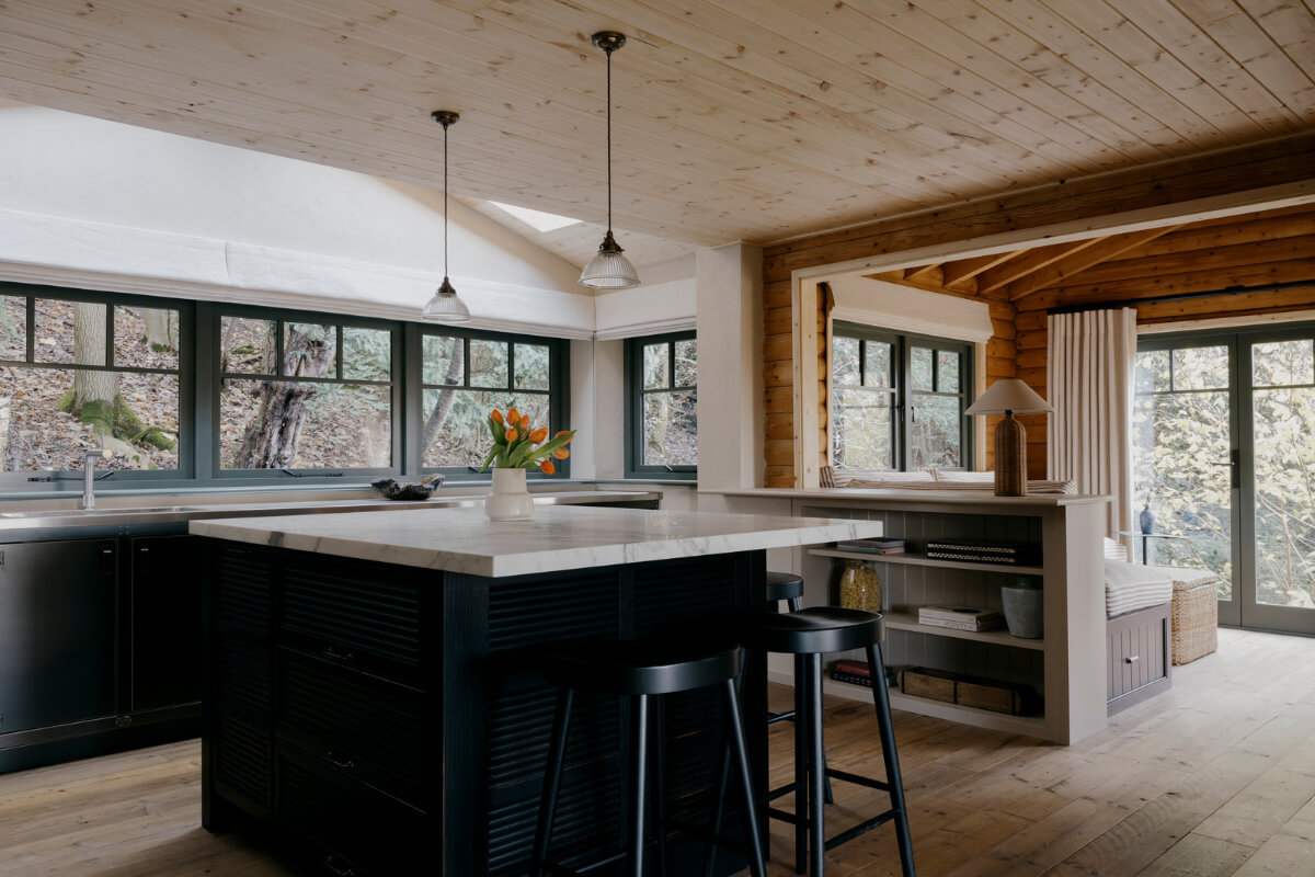 A Cozy and Contemporary Take on a Traditional Log House 5 open plan living space wooden ceiling kitchen island