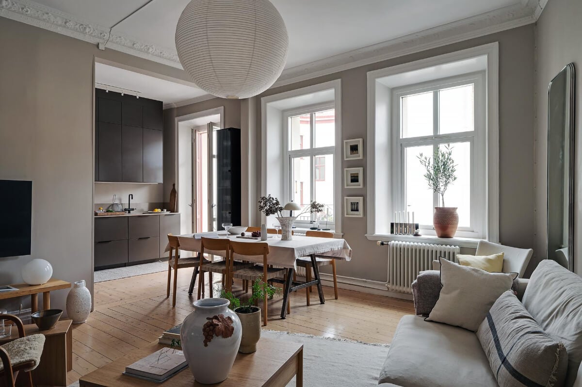 A Gothenburg Apartment with a Small Dark Green Bedroom 1 open plan living space wooden floor black kitchen